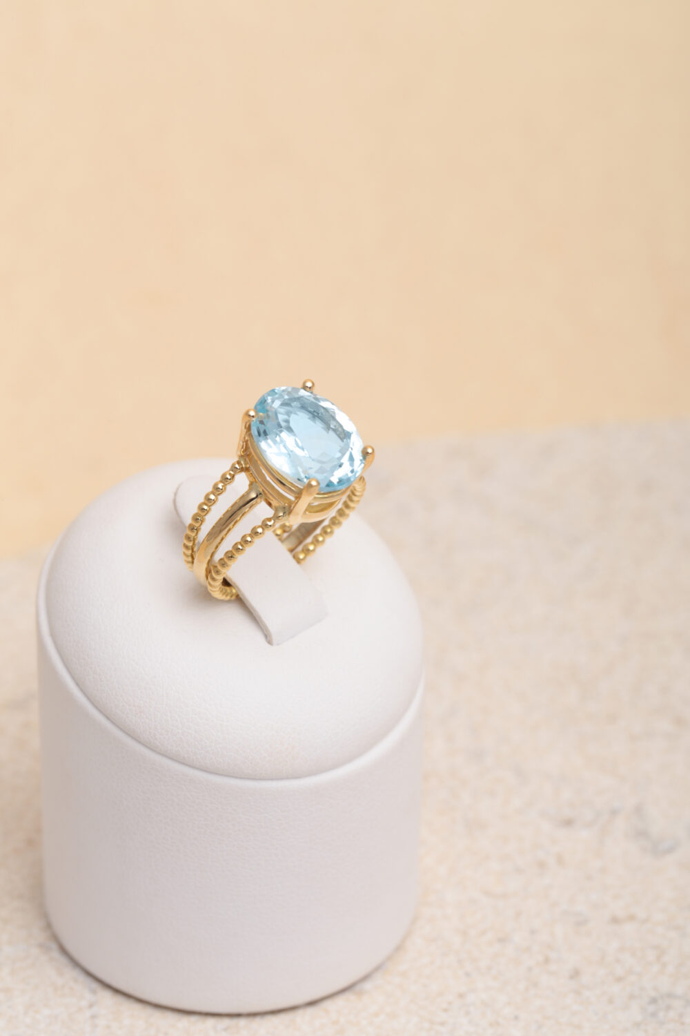 Oval aquamarine ring in 18-karat yellow gold set with a Aquamarine gemstone. All our jewellery is handmade by jewellery designer Pascale Masselis.