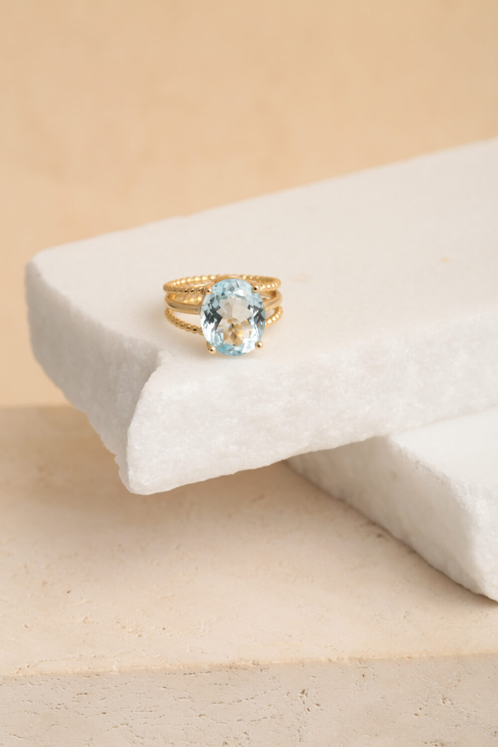 Oval aquamarine ring in 18-karat yellow gold set with a Aquamarine gemstone. All our jewellery is handmade by jewellery designer Pascale Masselis.