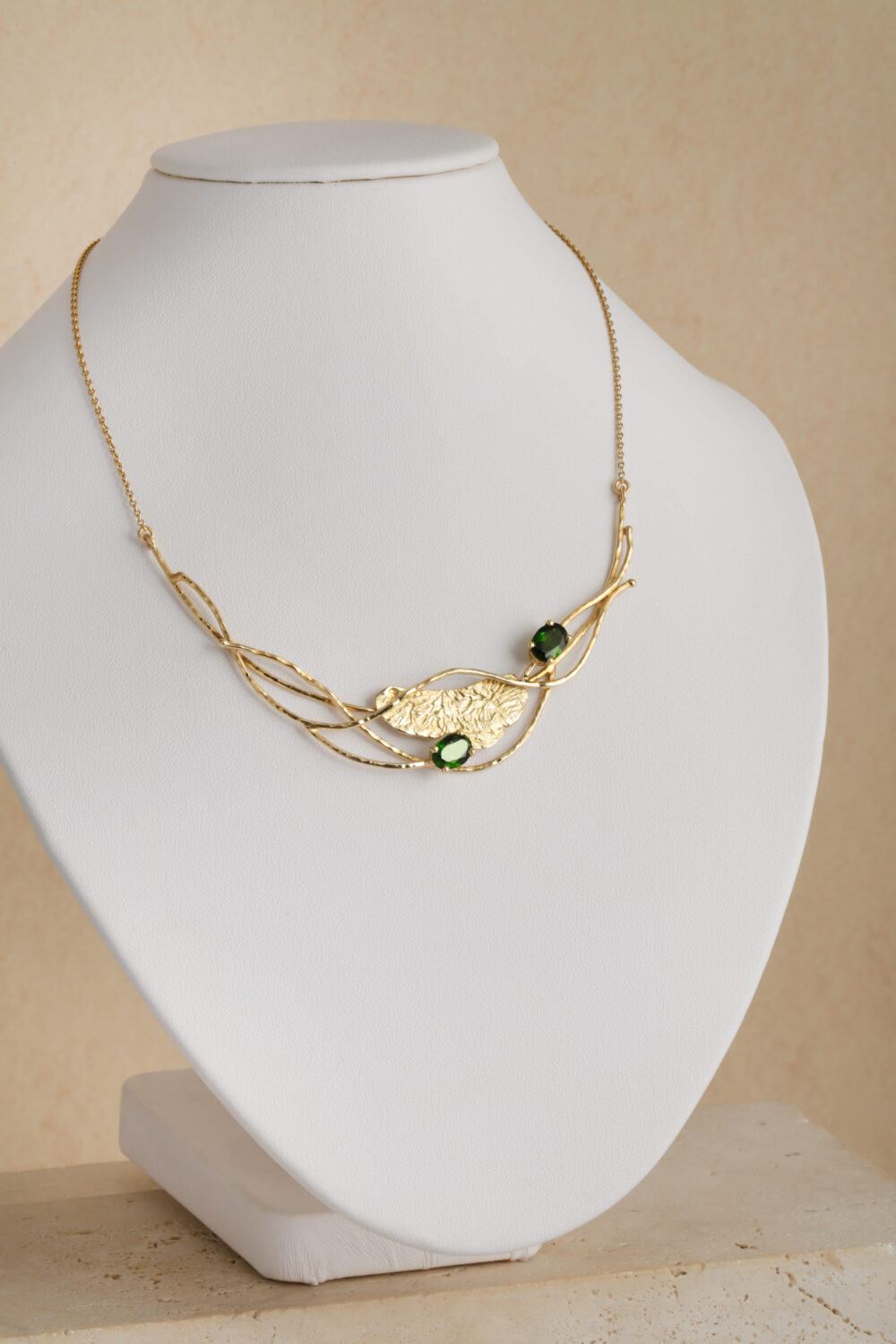 Necklace crafted from 18-karat yellow gold set with two oval cut green Diopsite gemstones.