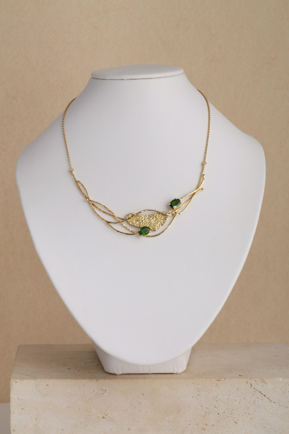 Necklace crafted from 18-karat yellow gold set with two oval cut green Diopsite gemstones.