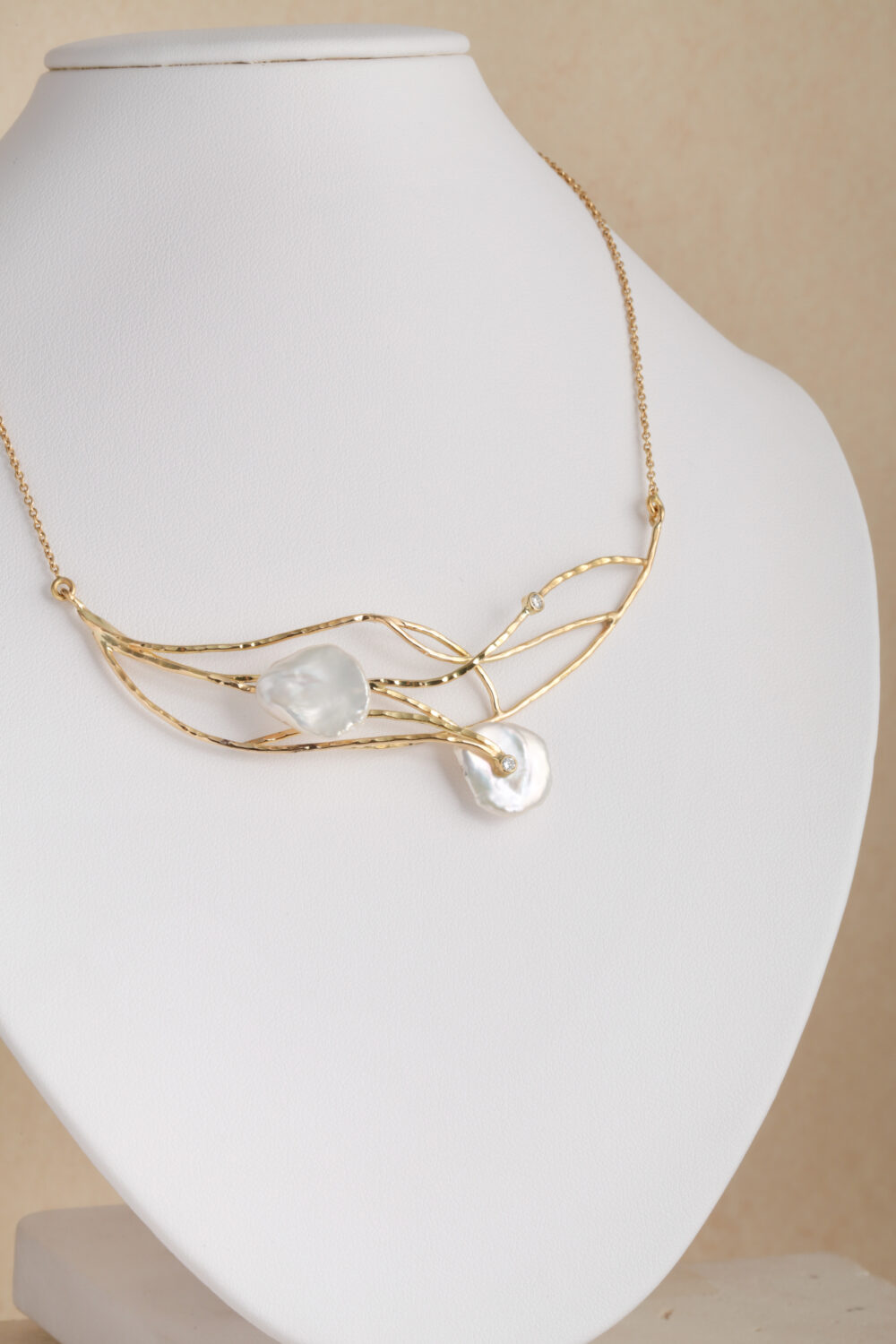 Necklace crafted from 18-karat yellow gold set with two brilliant cut diamonds and two baroque, natural pearl gemstones.
