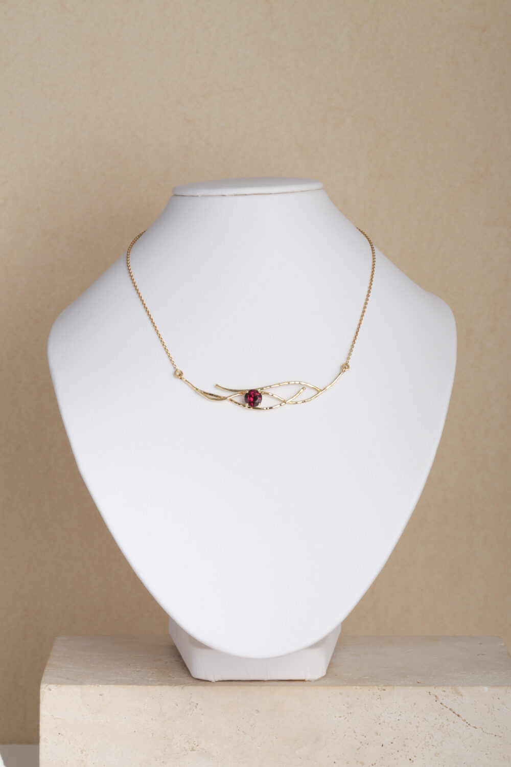 Necklace crafted from 18-karat gold set with a round cut garnet gemstone. All our jewellery is handmade by jewellery designer Pascale Masselis in our Antwerp based atelier.