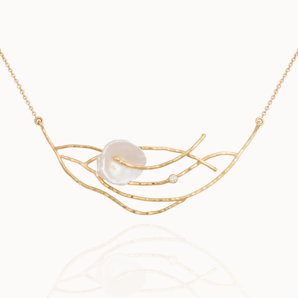Necklace crafted from 18-karat gold set with a brilliant cut diamond and a baroque, natural pearl.