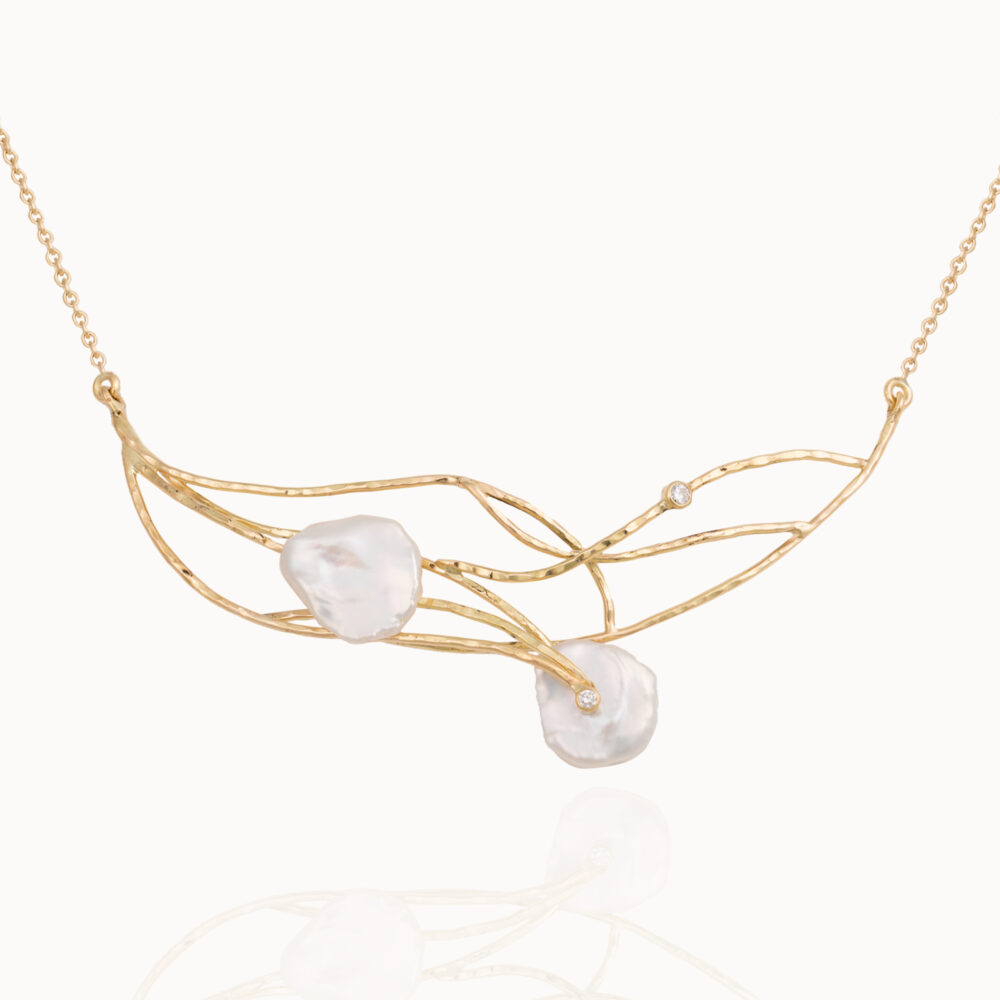 Necklace crafted from 18-karat yellow gold set with two brilliant cut diamonds and two baroque, natural pearl gemstones.