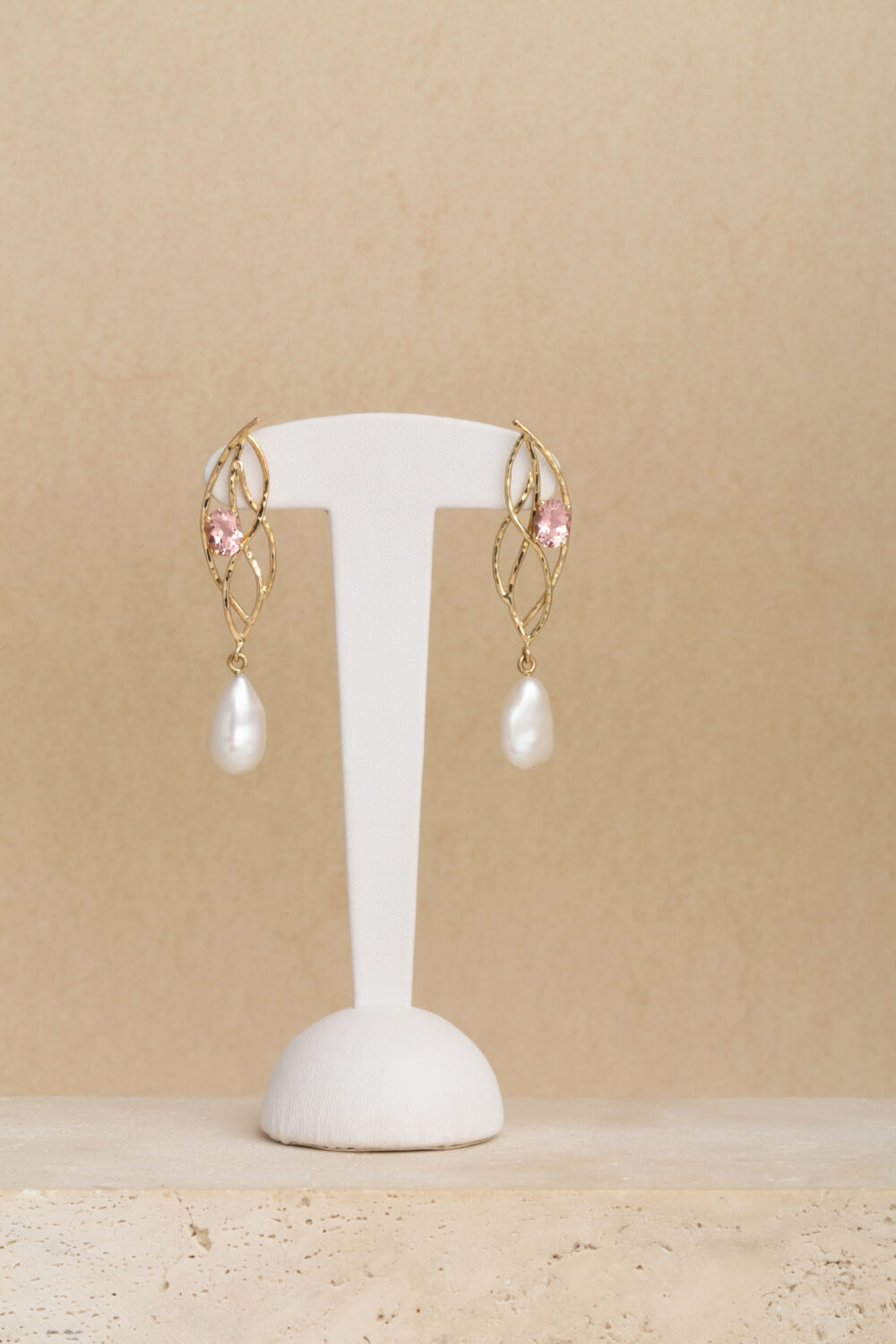 Morganite and Pearl earrings crafted from 18-karat yellow gold set with two oval cut morganite gemstones and two baroque drop-shaped pearls.