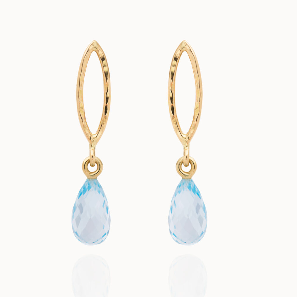 Crafted from 18-karat gold, the earrings feature drop-shaped Topaz gemstones.