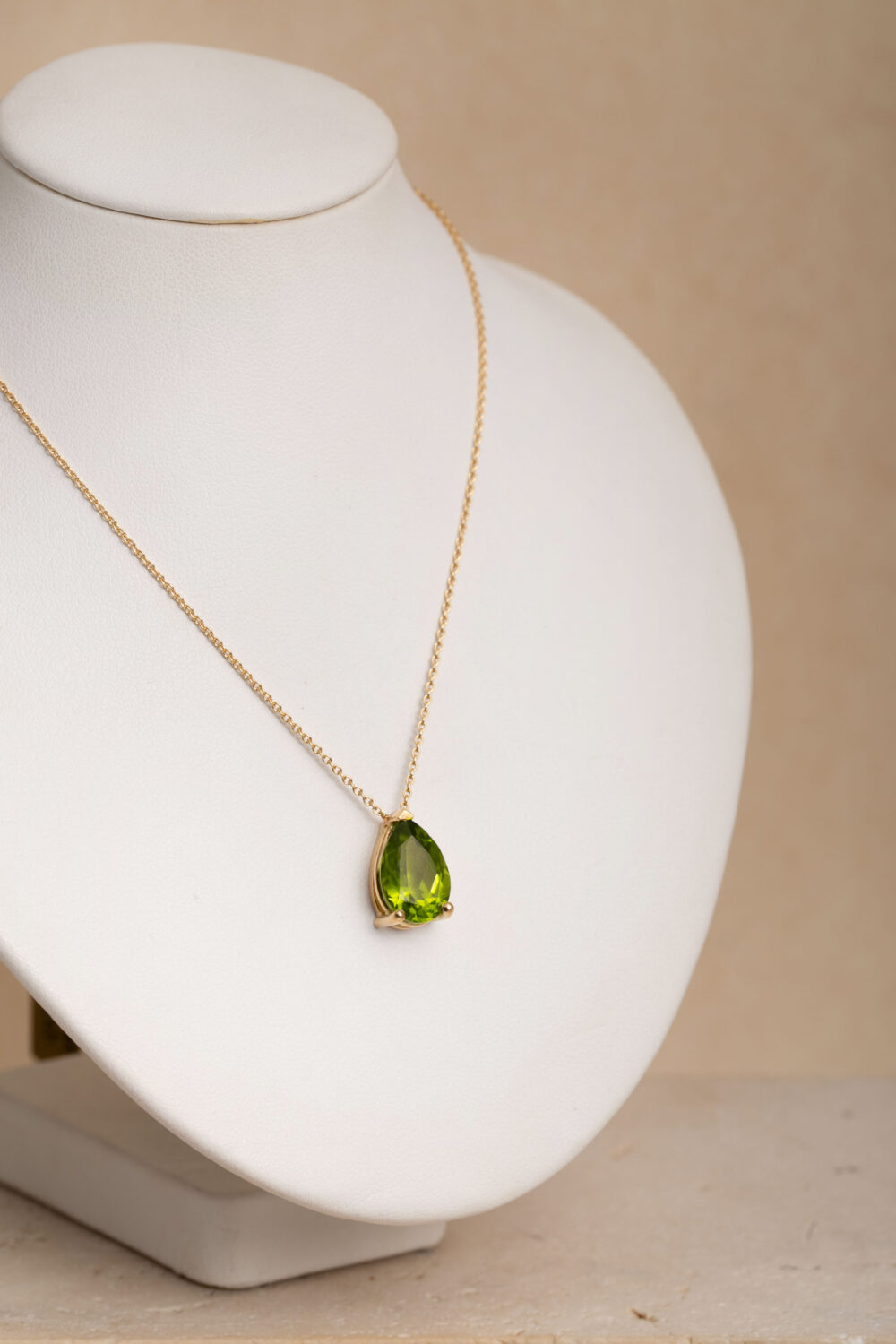 Necklace crafted from 18-karat gold with a pear shaped peridot gemstone hanger.