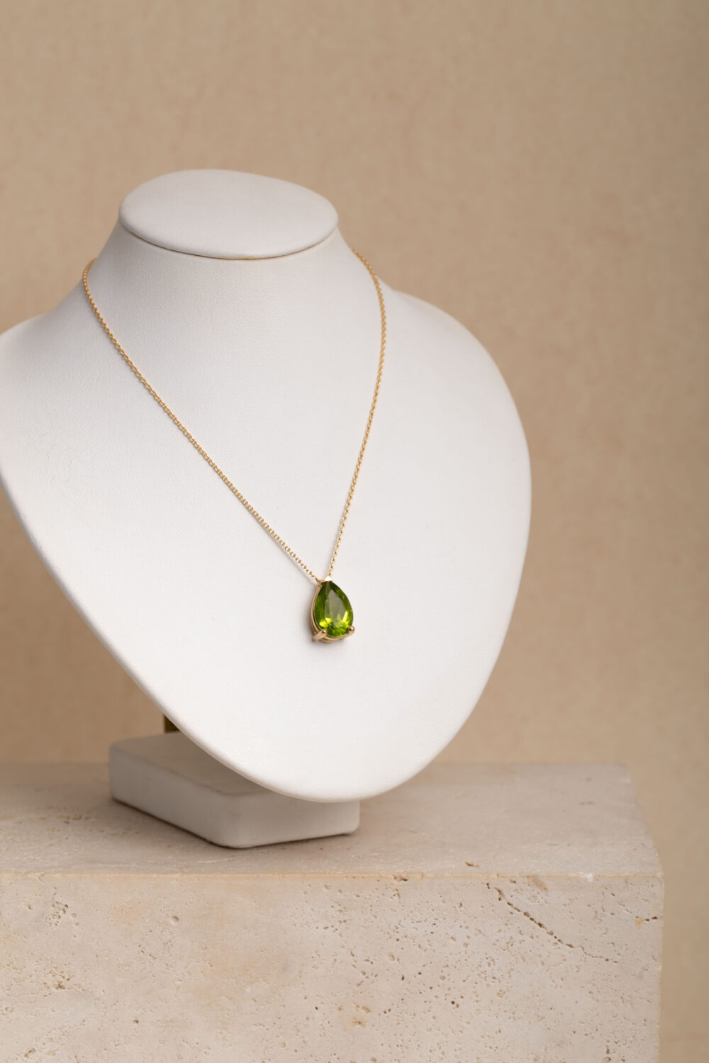 Necklace crafted from 18-karat gold with a pear shaped peridot gemstone hanger.